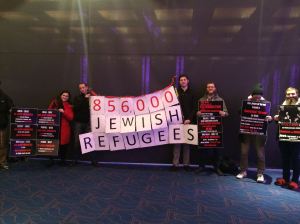 NYU students silently hold up facts on signs to protest SJP screening of ani-Israel film. Photo found on Mendy Boteach's Facebook page